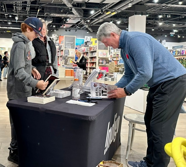 Bruce Dowbiggin signing copies of Deal With It at Indigo